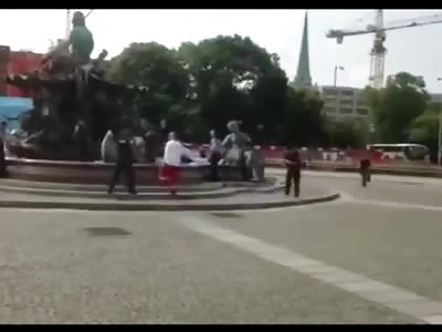 Deranged Naked Man Shot by Police in a Fountain after Stabbing Himself then Attacking Police with the Knife 