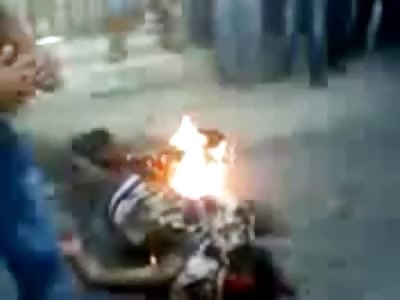 Just some Muslims starting a Bonfire in the Street with a Man as the Accelerant