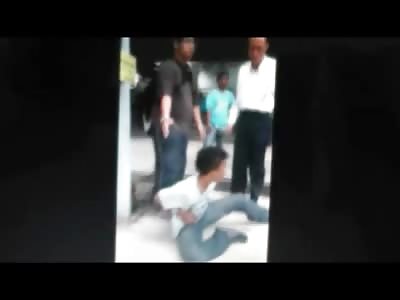 Well Dressed Business Man Kicks and Beats Tied up Thief on the Sidewalk