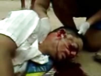 Man being Held by EMT as he Dies in the Street from Bullets