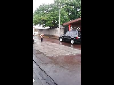 Just a Man Washing his Pants in the Dirty Rainwater 