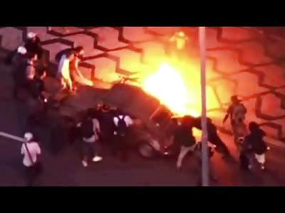 What a Mess! Car catches Fire in Brazil during Protest for the World Cup.People Trapped Inside 