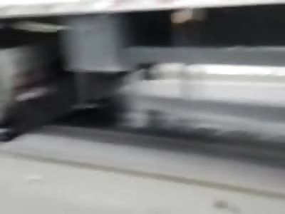 /Body Brutally Mangled Cut in Half after Being Crushed and Dragged Under Wheels of Semi-Truck