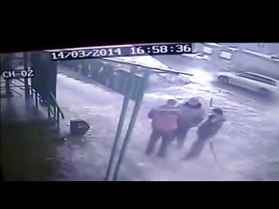 Watch out for Falling Icicles....Man Chatting with his Buddies is All but Decapitated 