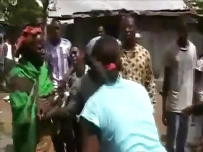 Poor Girl with Knife Wounds in her Back Being Helped