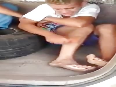 Brazilian Police Force a Gangster at Gun point to Remove a Tattoo From His Leg Using Sandpaper