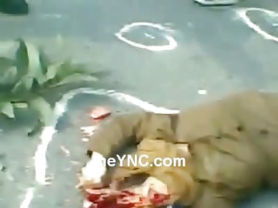 Woman with Her Head Crushed under Her Brown Scarf