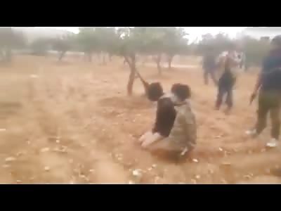 Two Men Being Executed with a Bullet Each in the Back of the Head .. And Then Machine Gun Clips are Unloaded on their Bodies