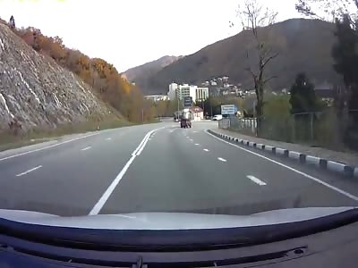 What Luck...Guy On The Side Of The Road Gets Ricochet Runaway Tire  To The Face, Knocking Him Out Cold