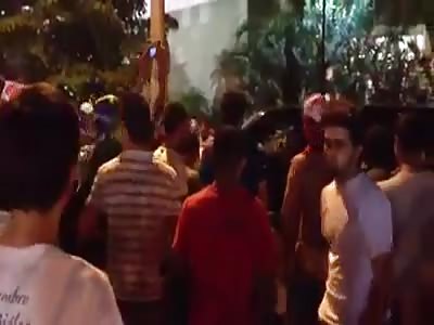 During protests in Brazil, angry driver runs over the crowd, killing one.