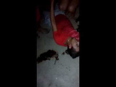 Dying Kid in the Street has His Gold taken Off by Family Members