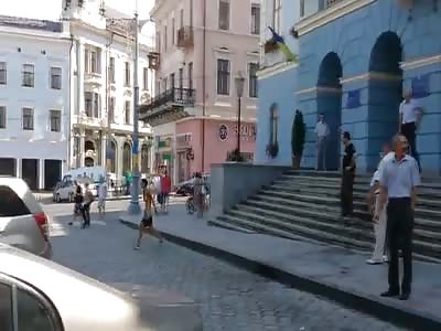 Ukrainian girl dissatisfied with corrupt Ukrainian government breaks the glass in the administrative building 