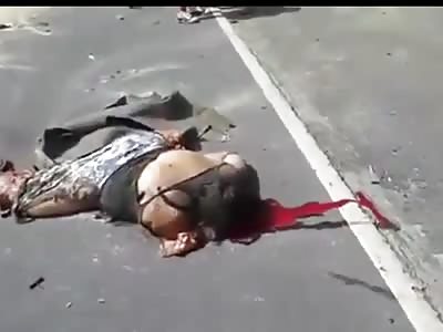 Two Mangled Bodies on Road After Car Crash with Semi Truck