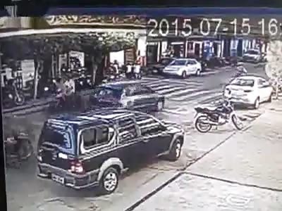 Motorcyclist slams into the back of a car and does short handstand stunt 